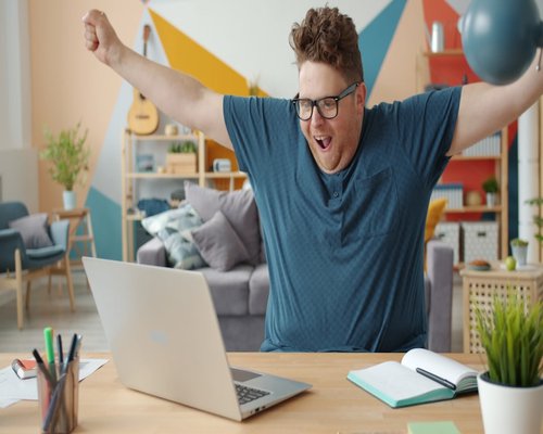 Person stretching arms while sitting at a desk